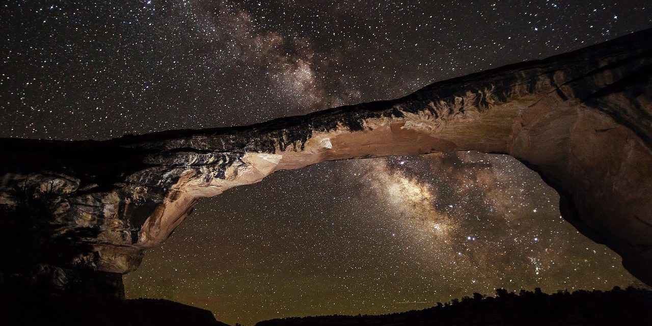 A bridge with a starry sky in the background