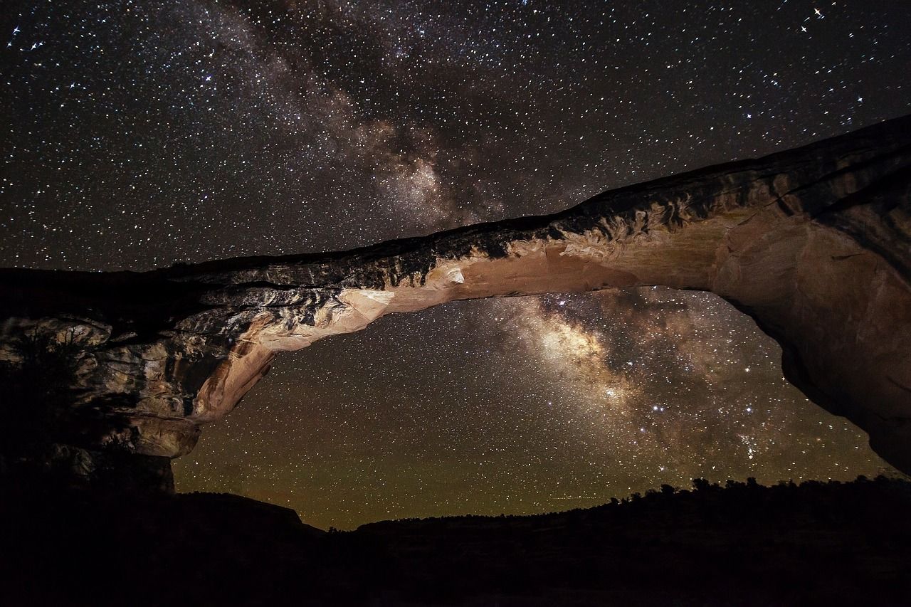 A bridge with a starry sky in the background