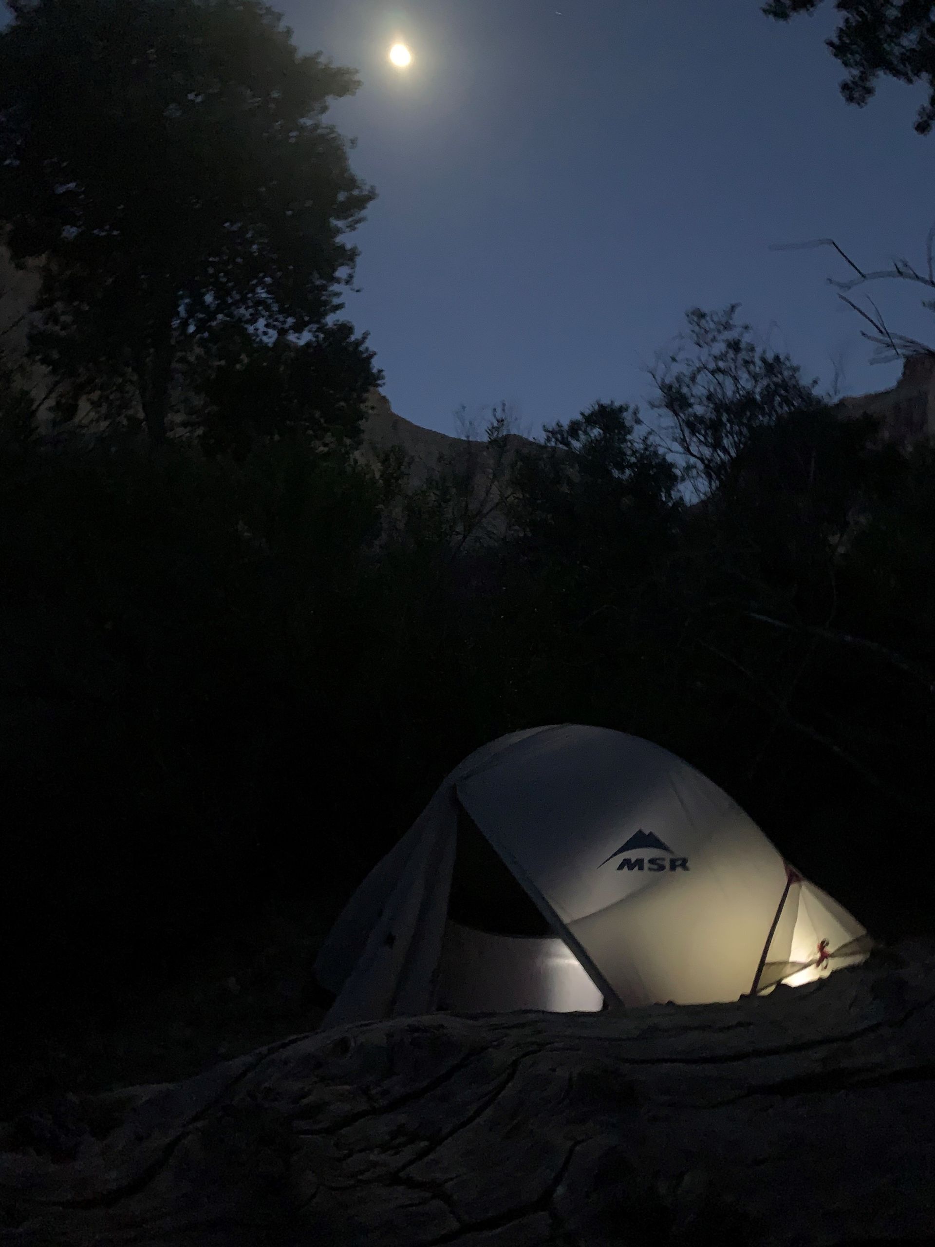 A msr tent is lit up in the dark