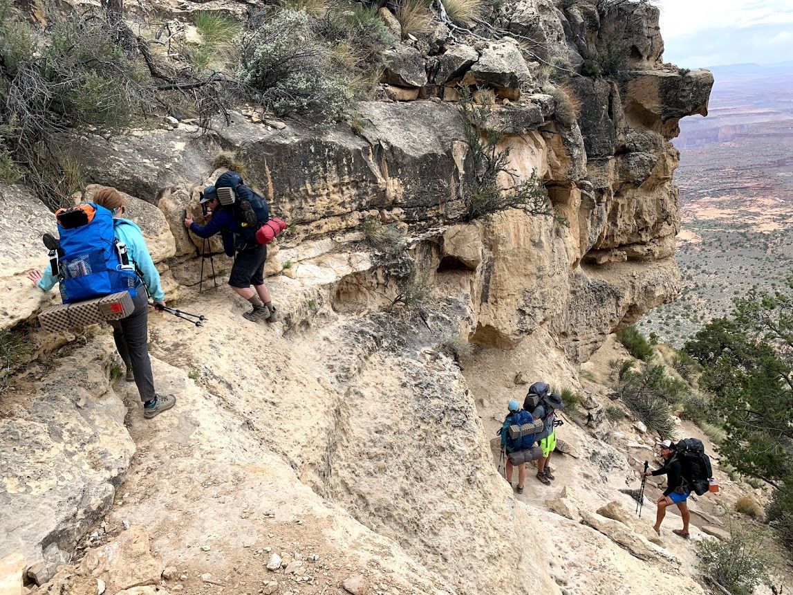 A group of people are hiking up a mountain.