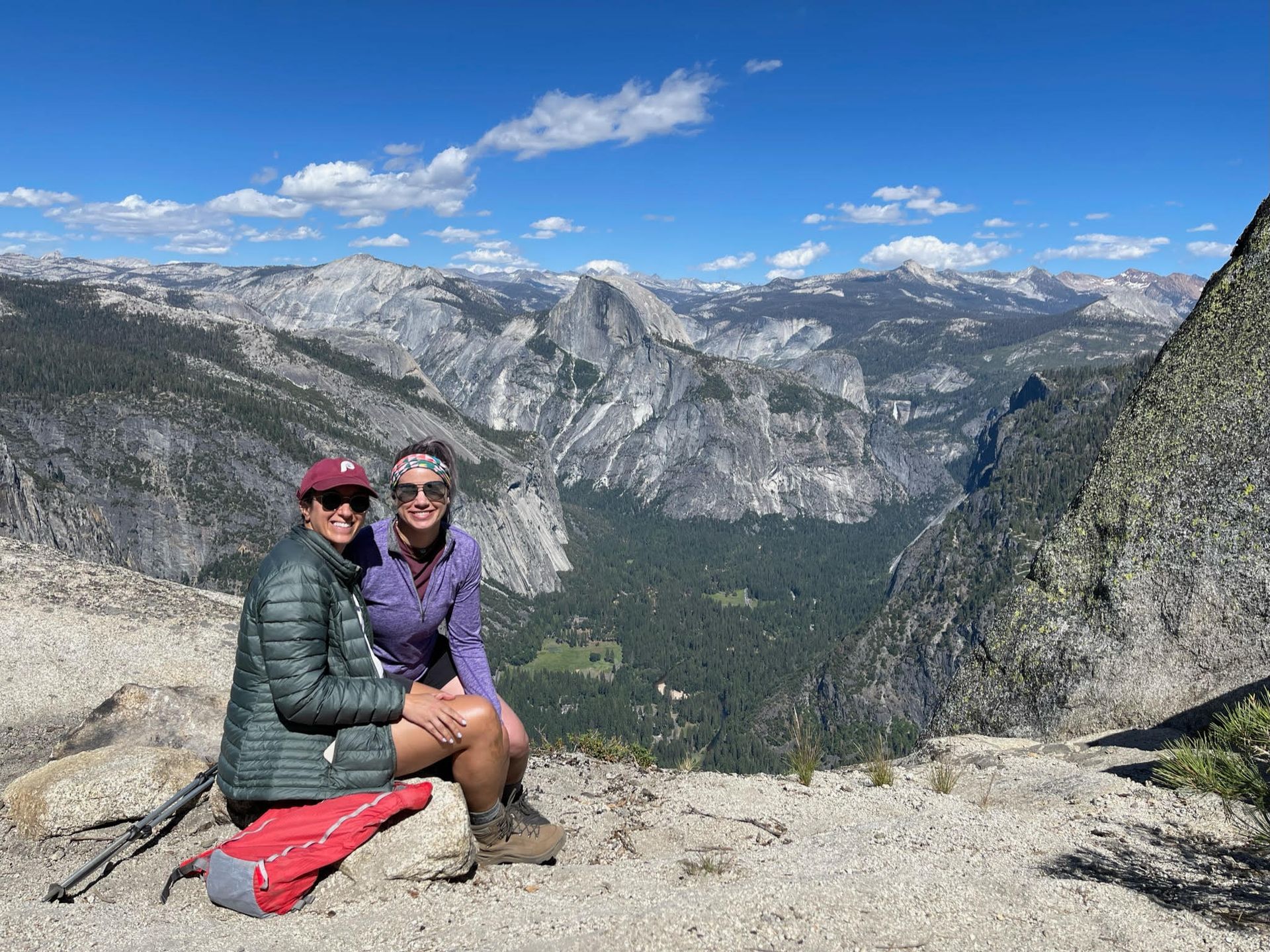 Two people are posing for a picture on top of a mountain.