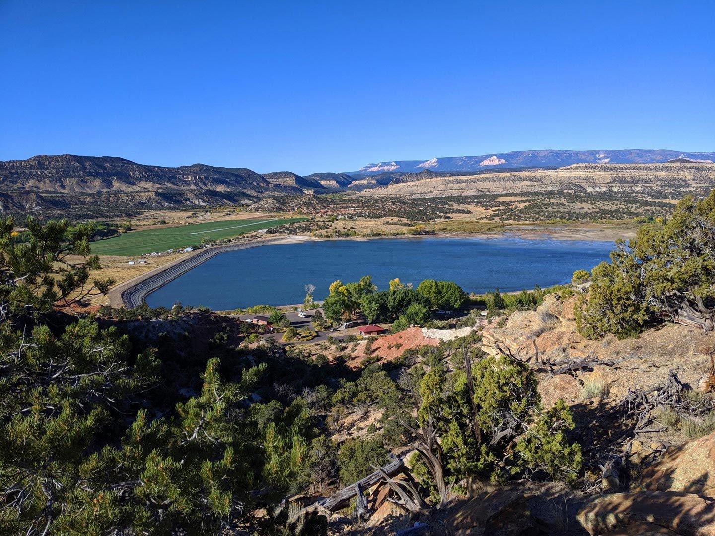 A large body of water surrounded by mountains and trees