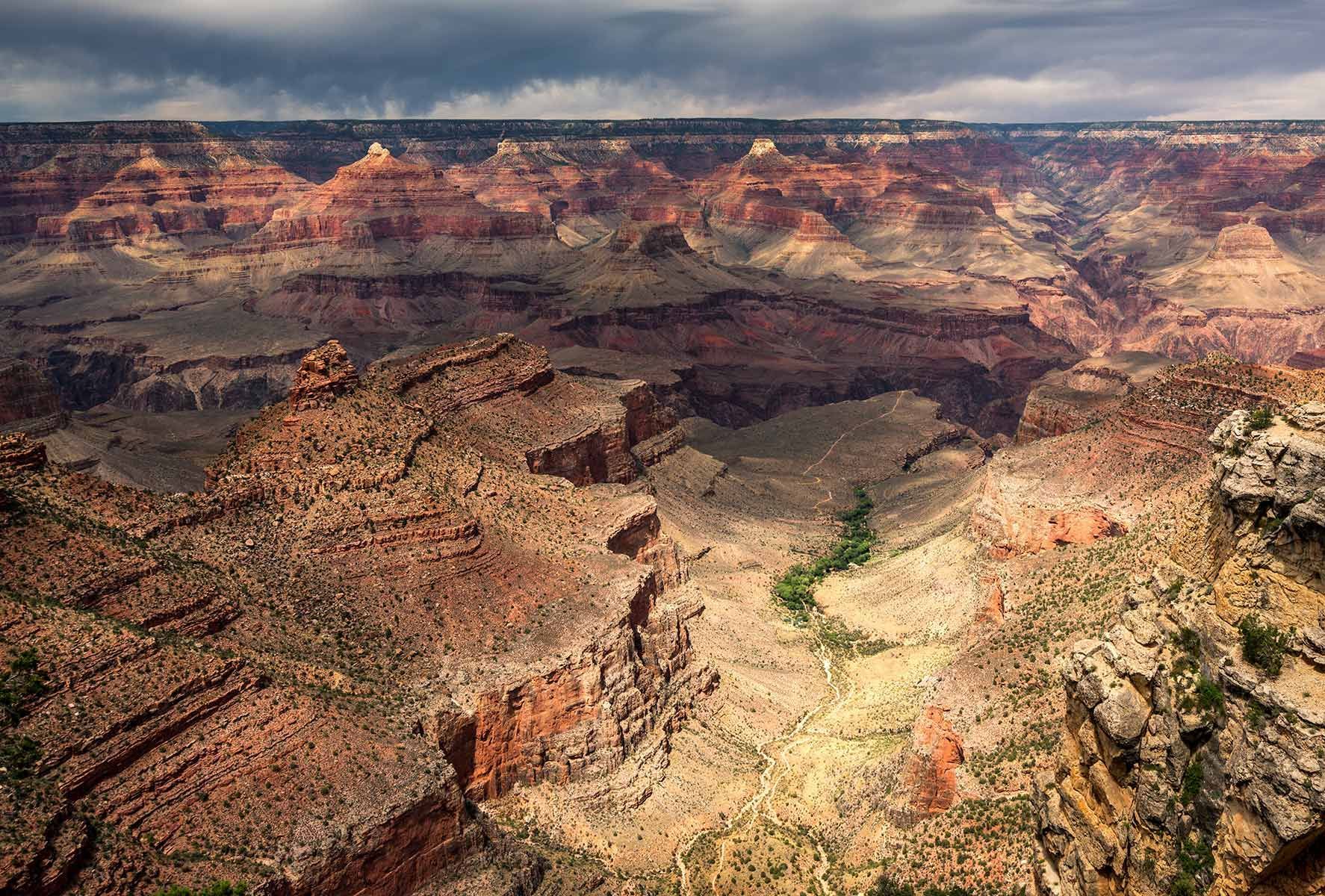 An aerial view of the grand canyon on a cloudy day.