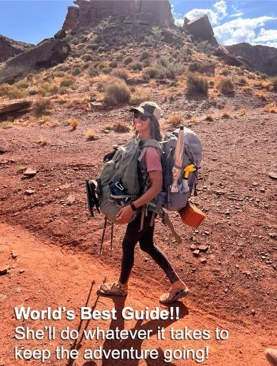 A woman with a backpack is walking in the desert.