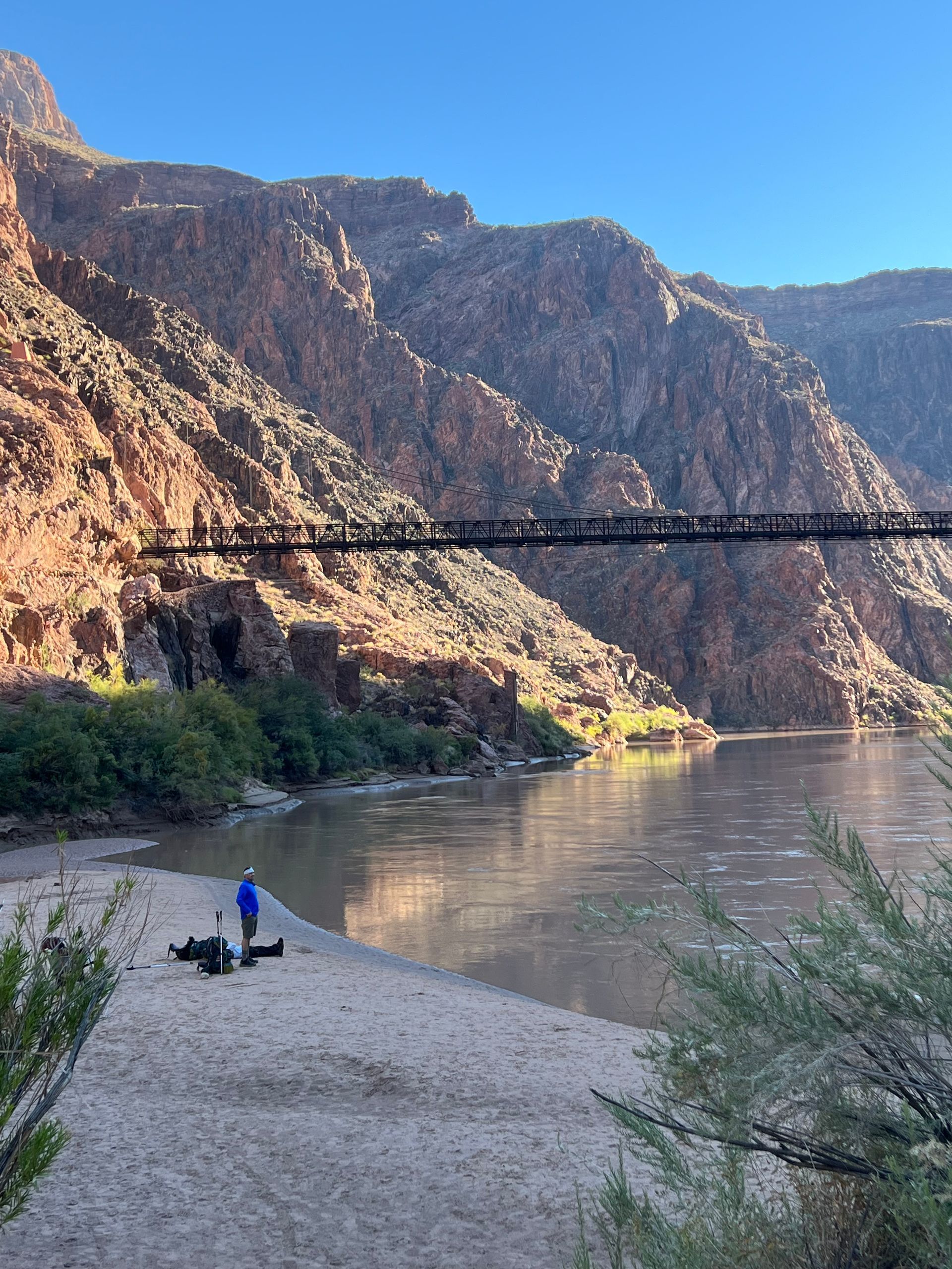 A bridge over a river with mountains in the background