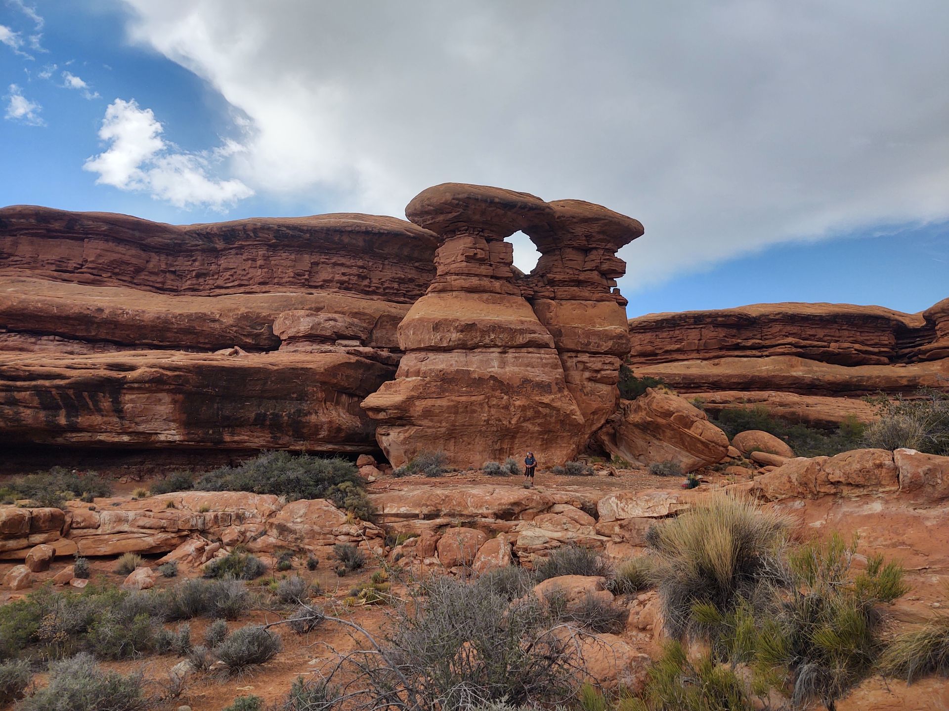 A large rock formation in the middle of a desert.