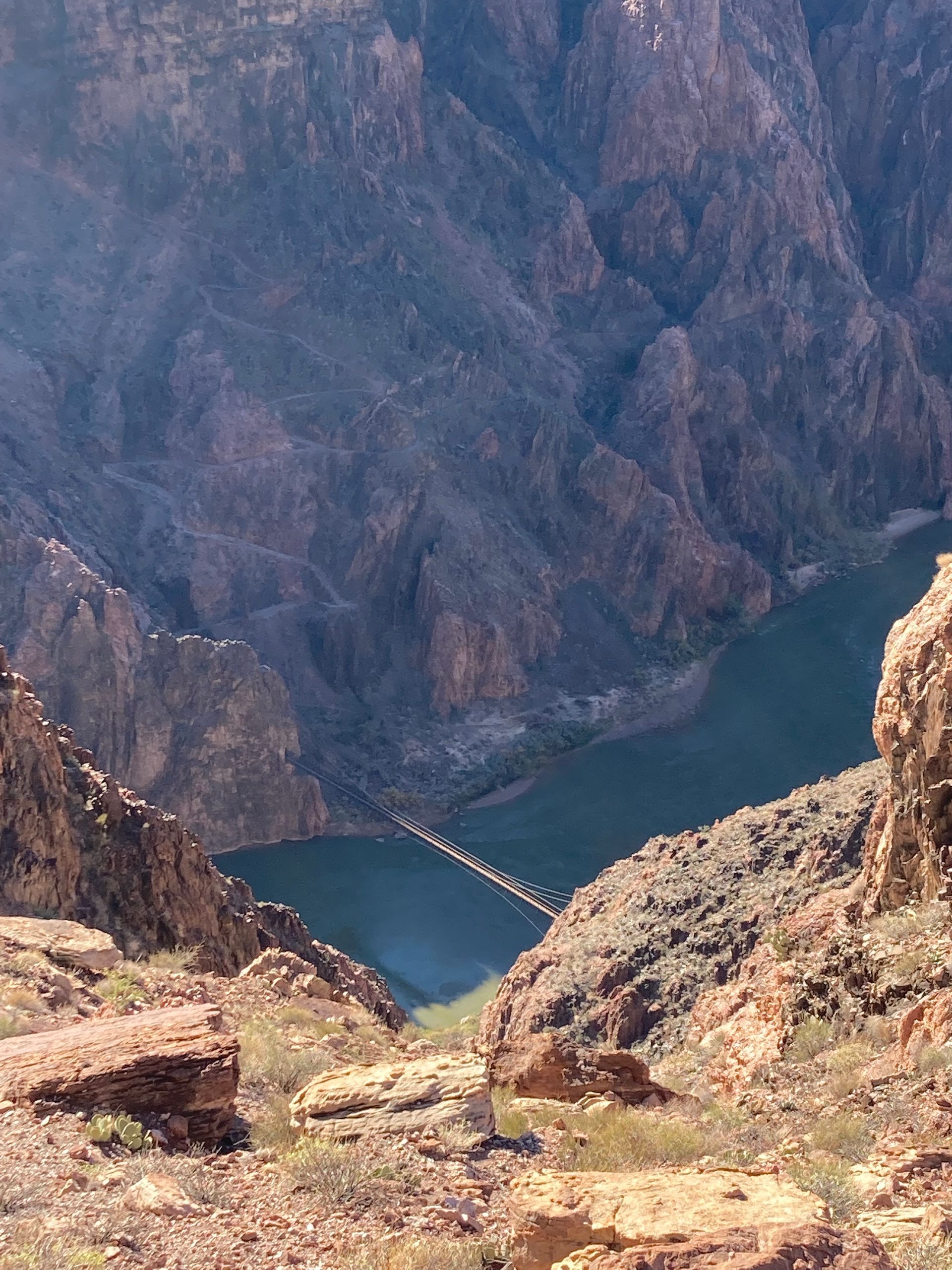 A bridge over a river in the middle of a canyon