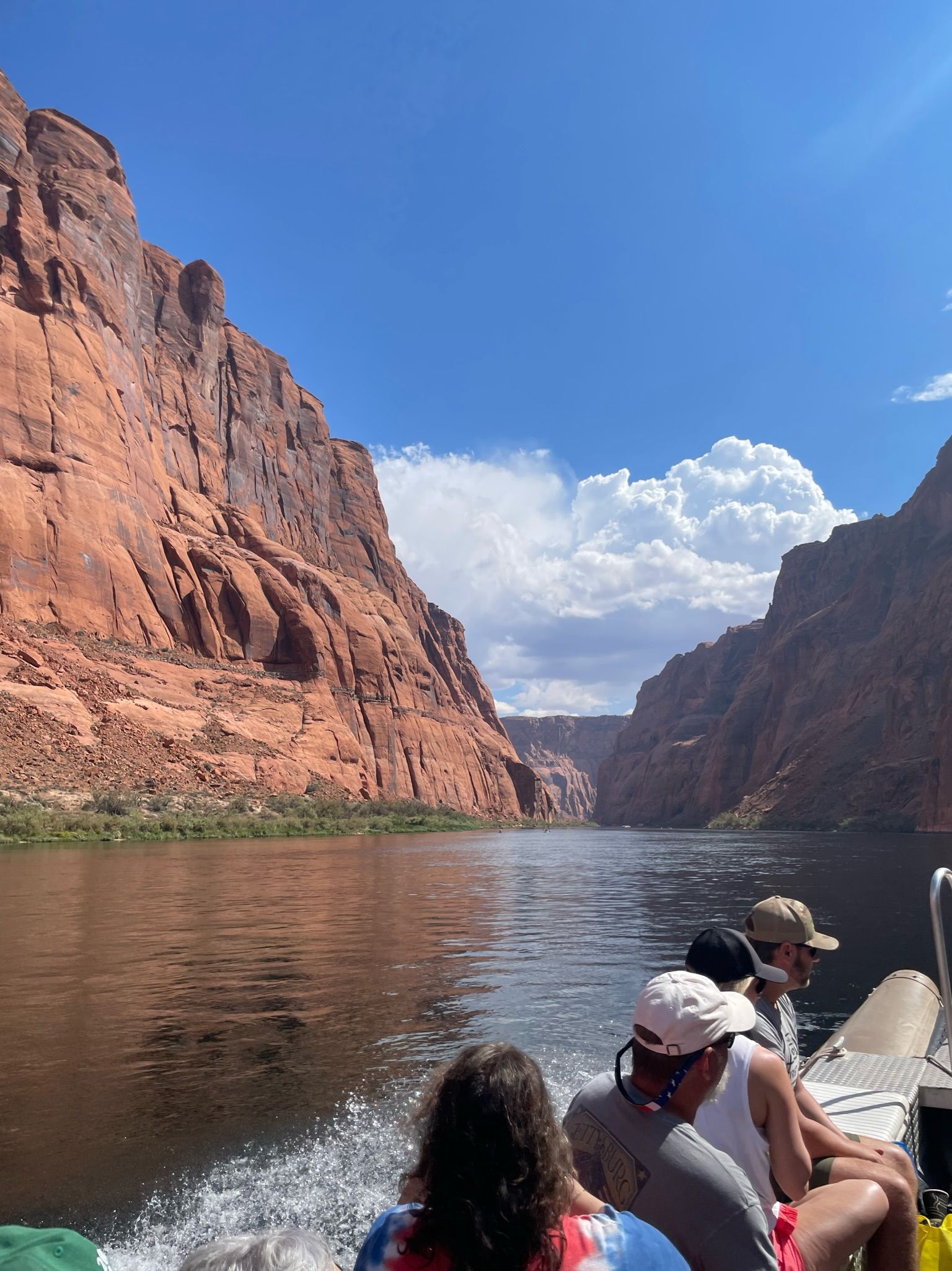 A group of people are riding a boat down a river.