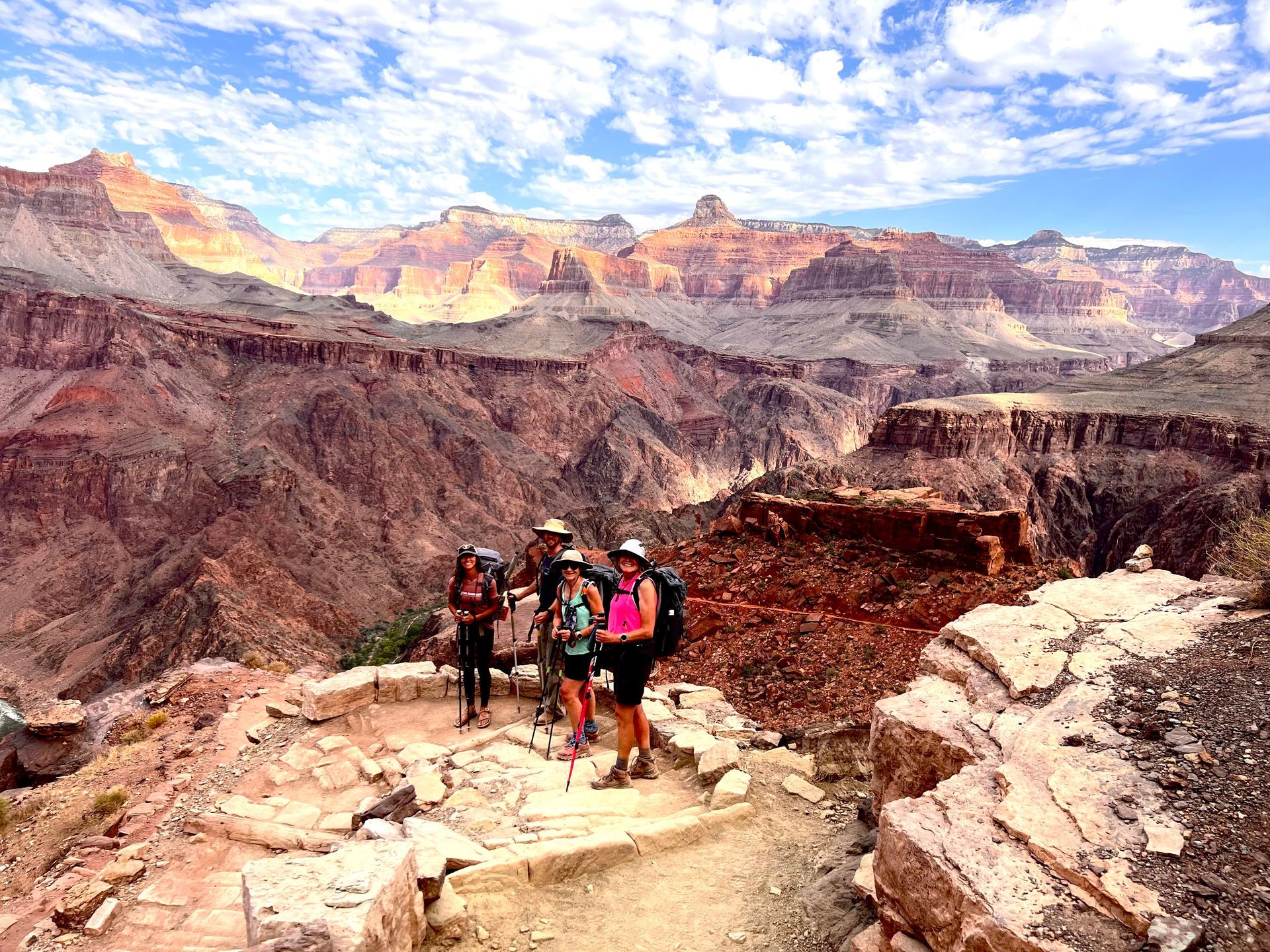 A group of people are standing on top of a mountain.