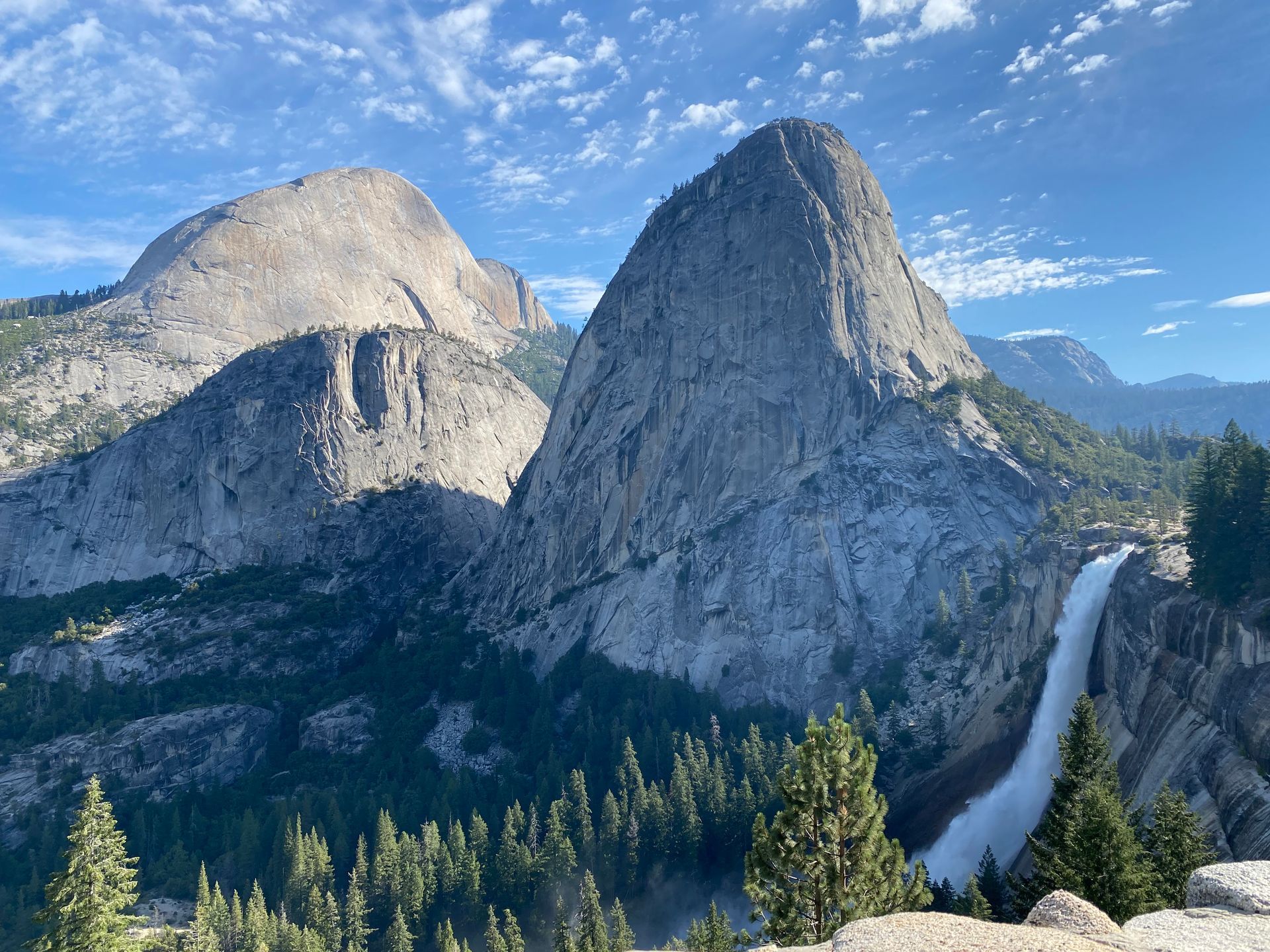 There is a waterfall in the middle of the mountains.