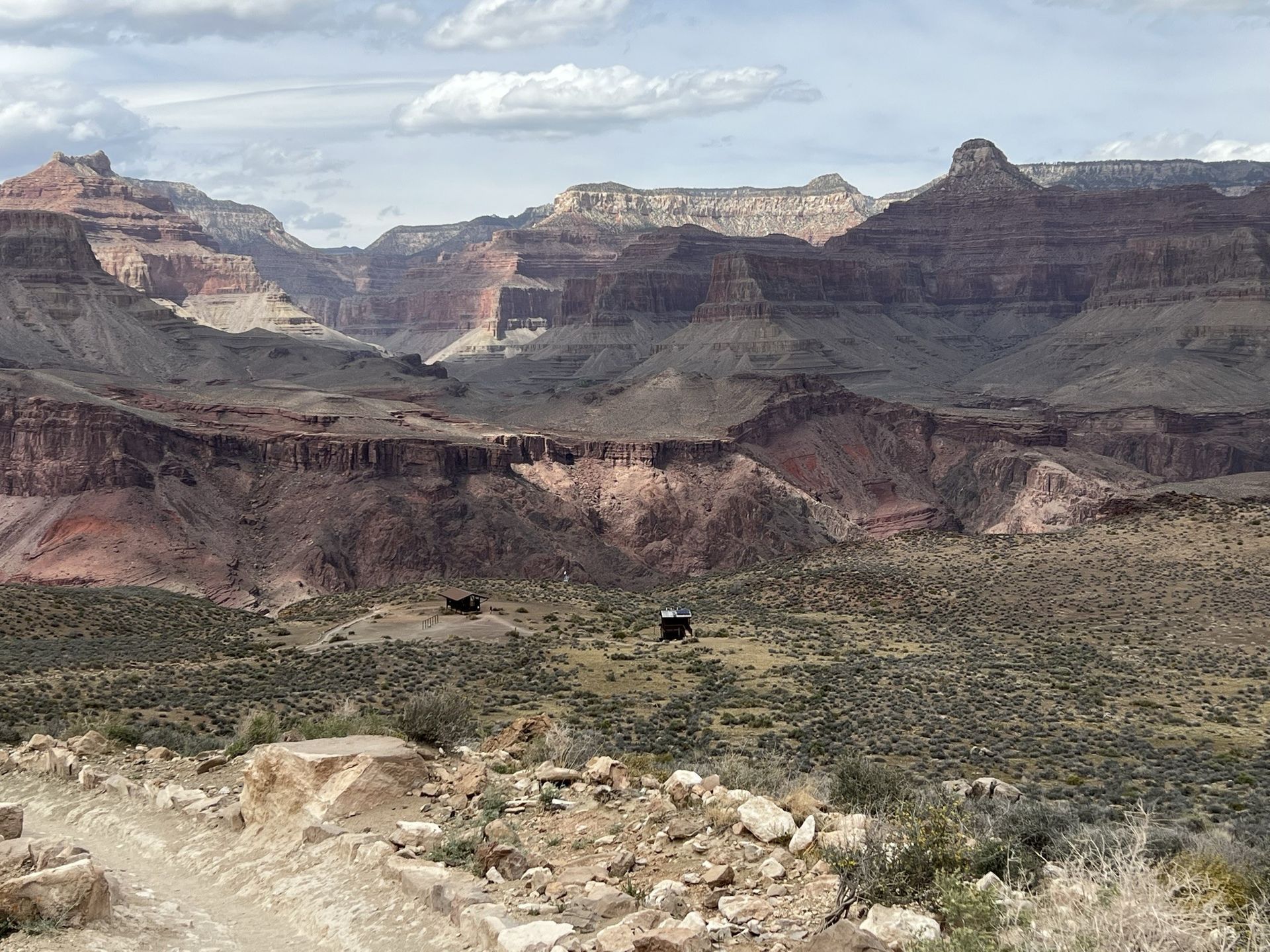 A view of the grand canyon with mountains in the background