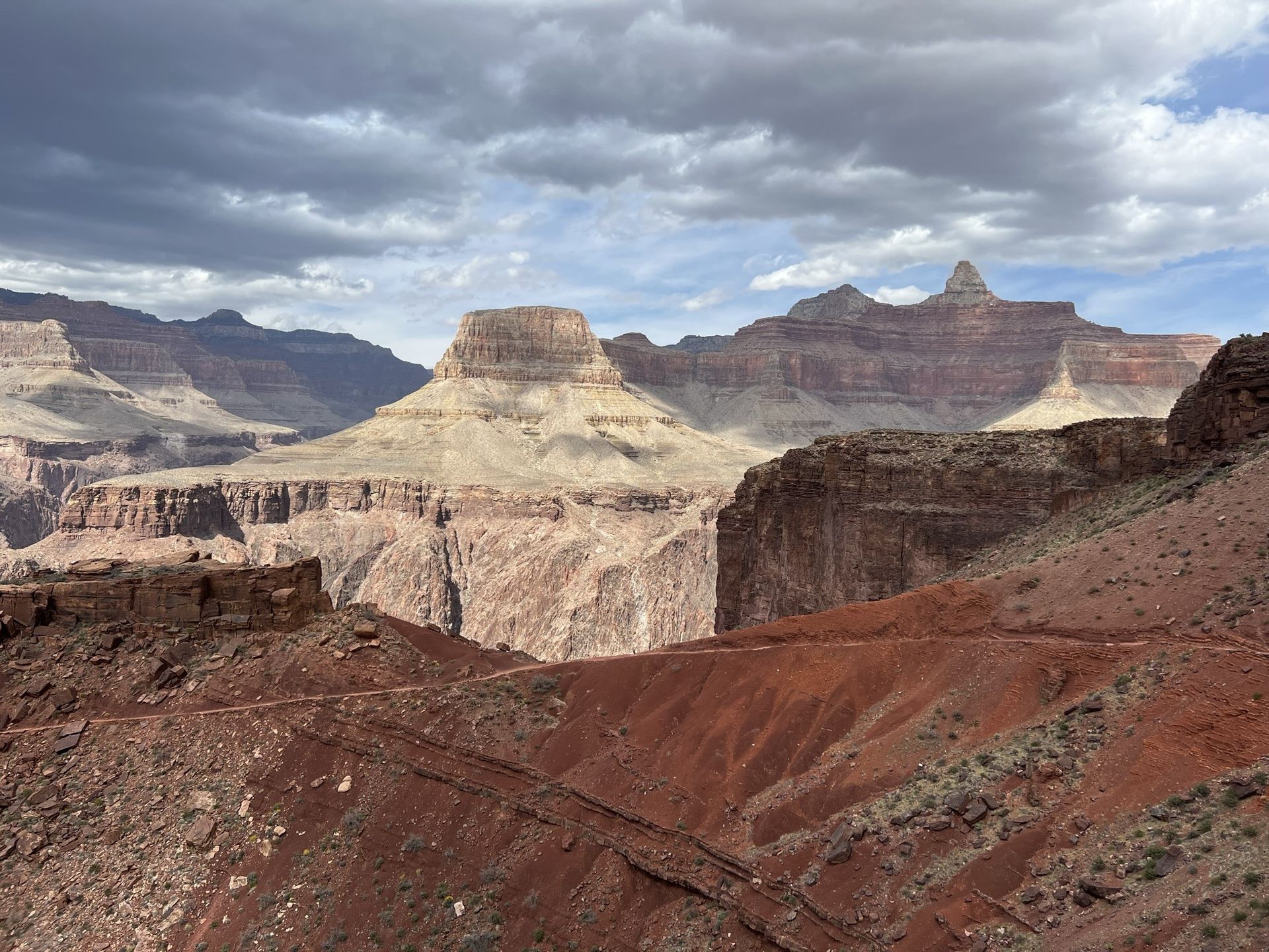 A view of the grand canyon with mountains in the background