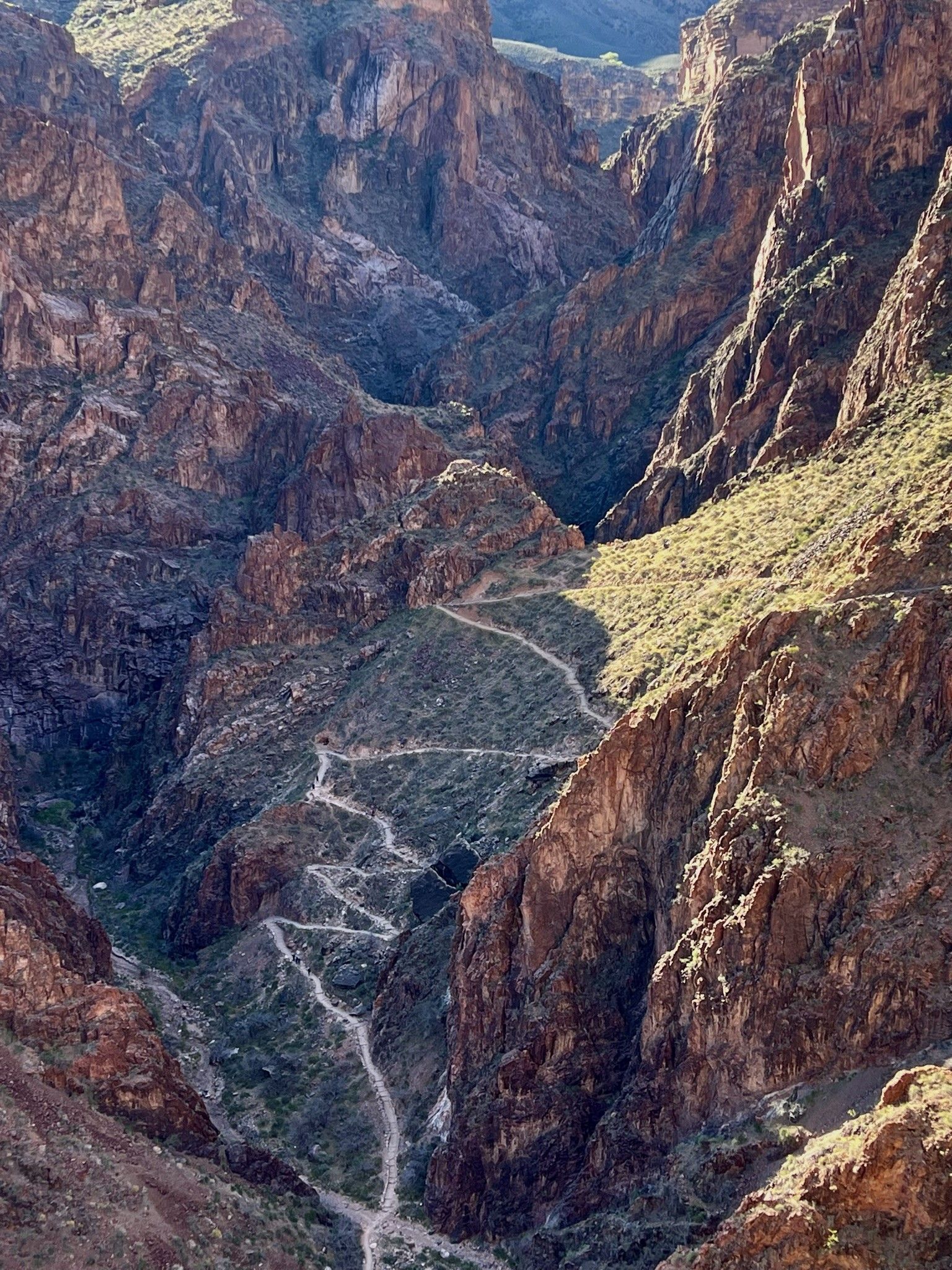 An aerial view of a canyon with a road going through it.