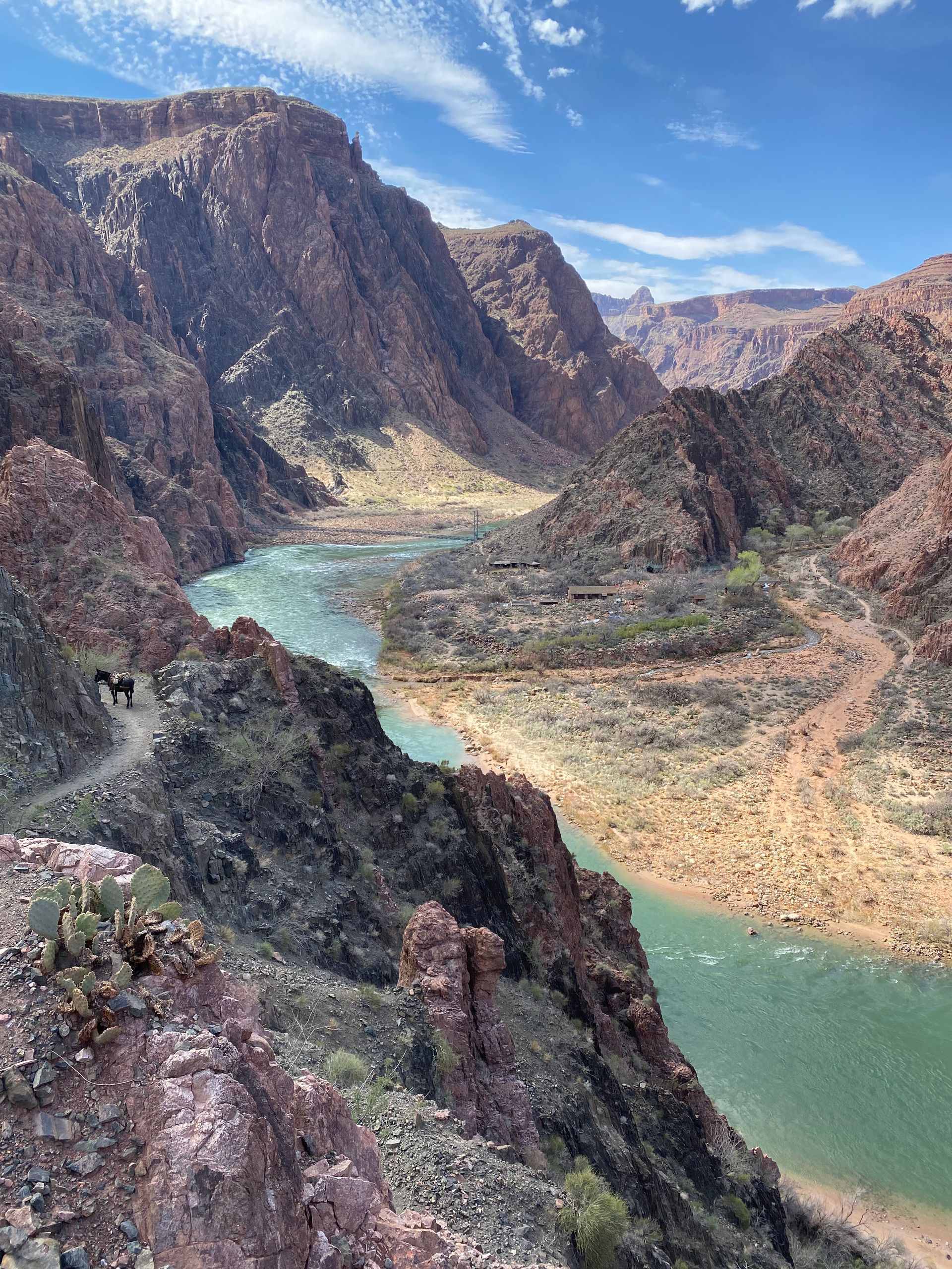 A river runs through a canyon between two mountains.