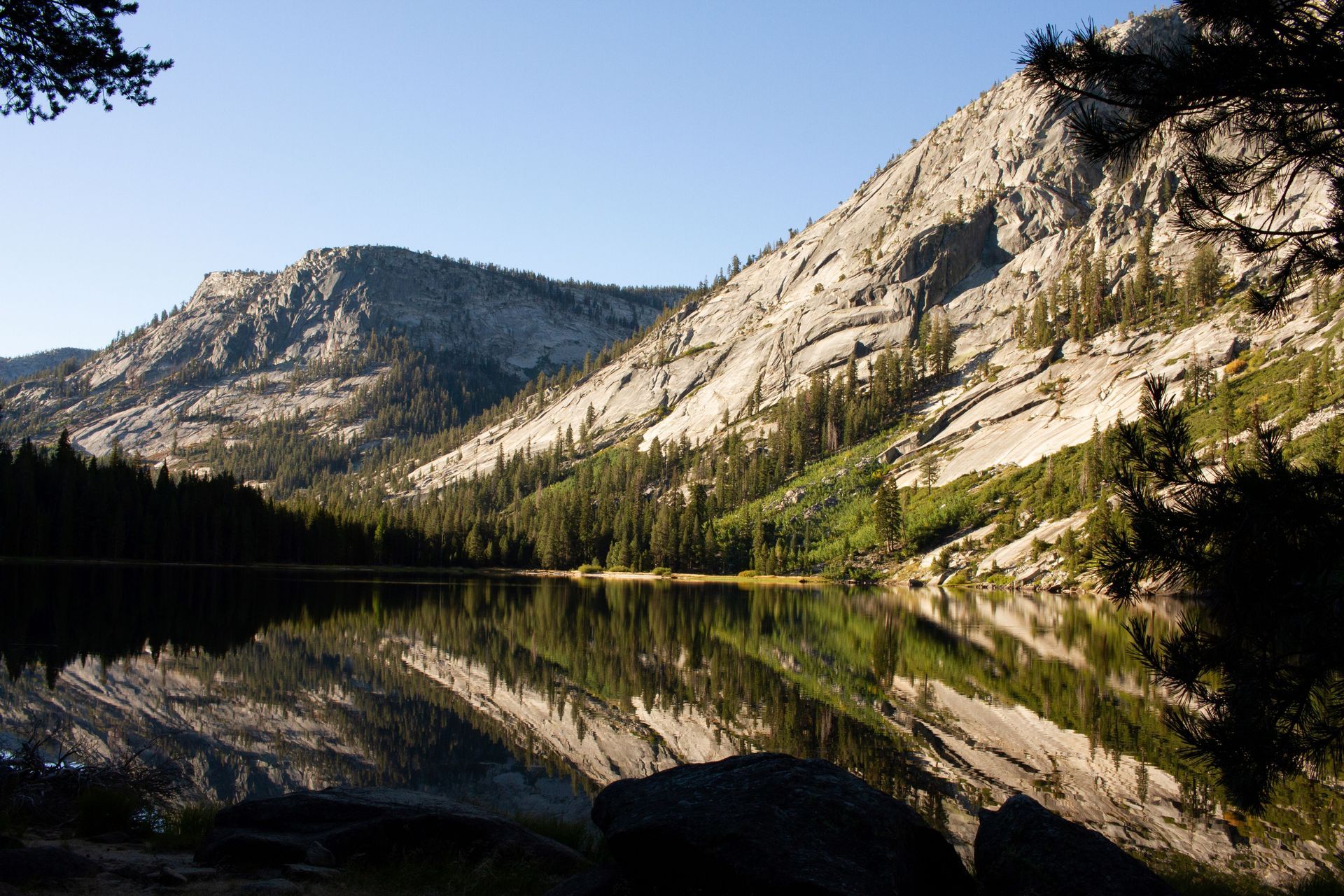 A lake with mountains in the background and trees on the shore