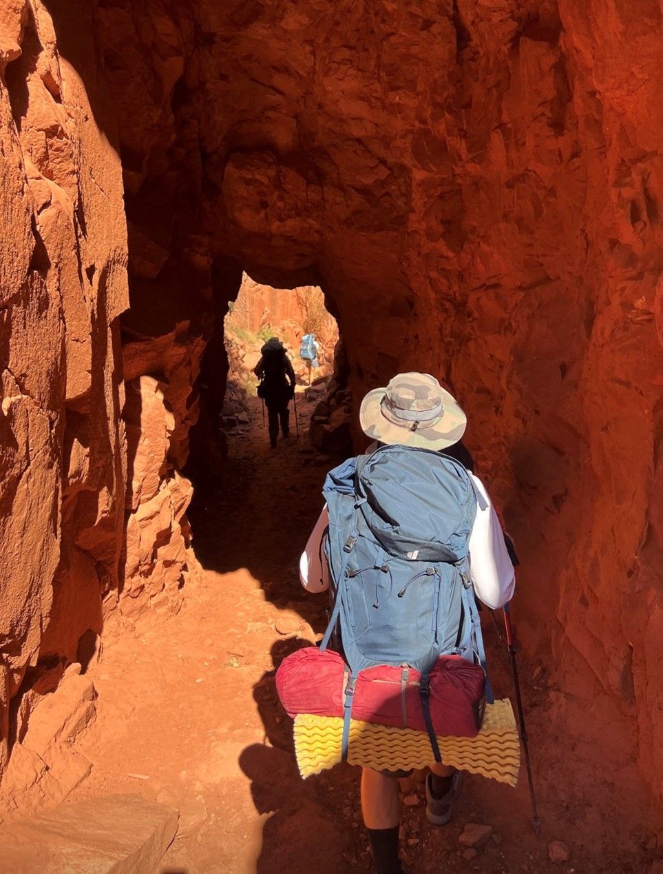 A person is walking through a tunnel in the desert.