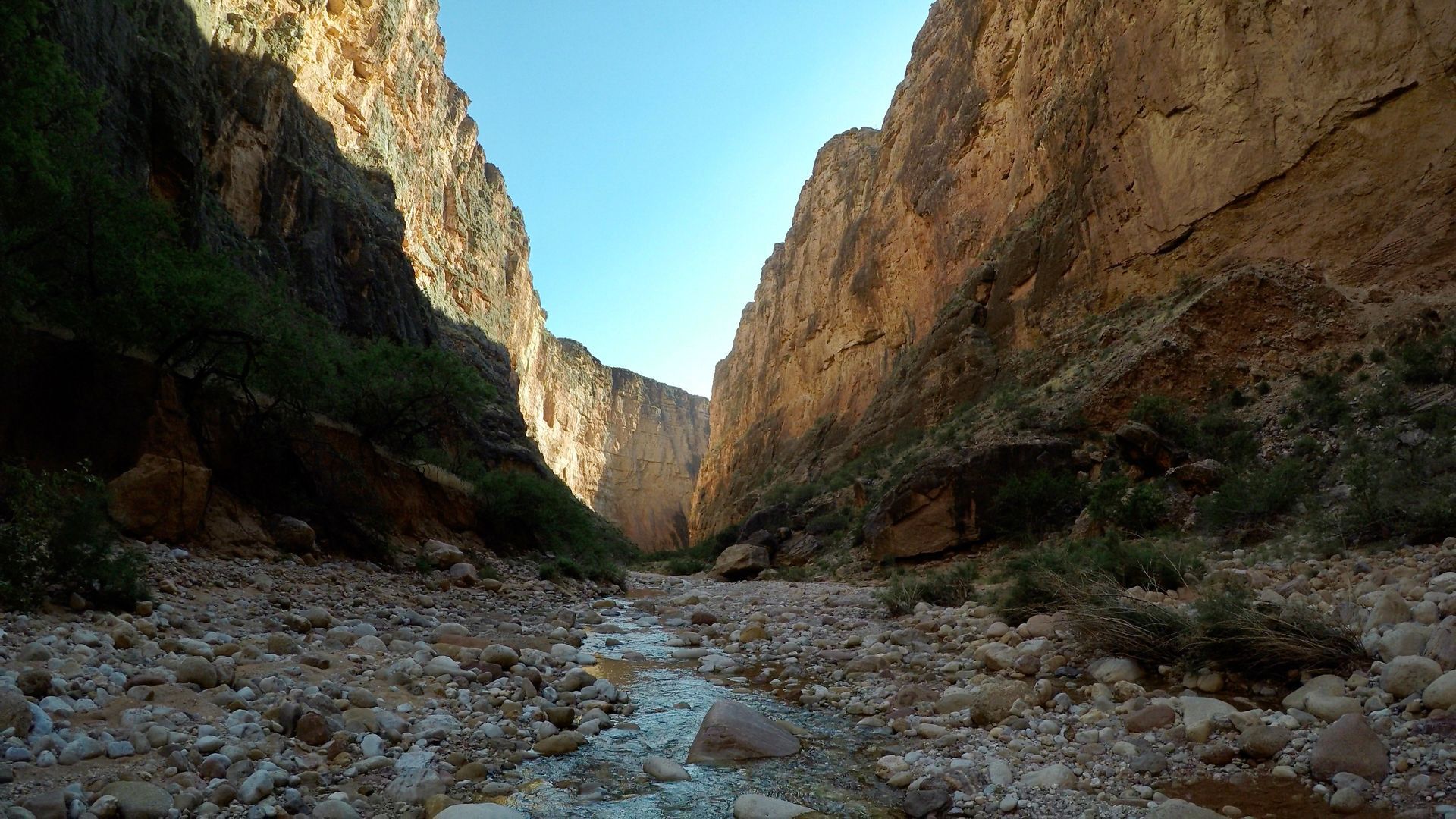 A river running through a rocky canyon between two mountains.