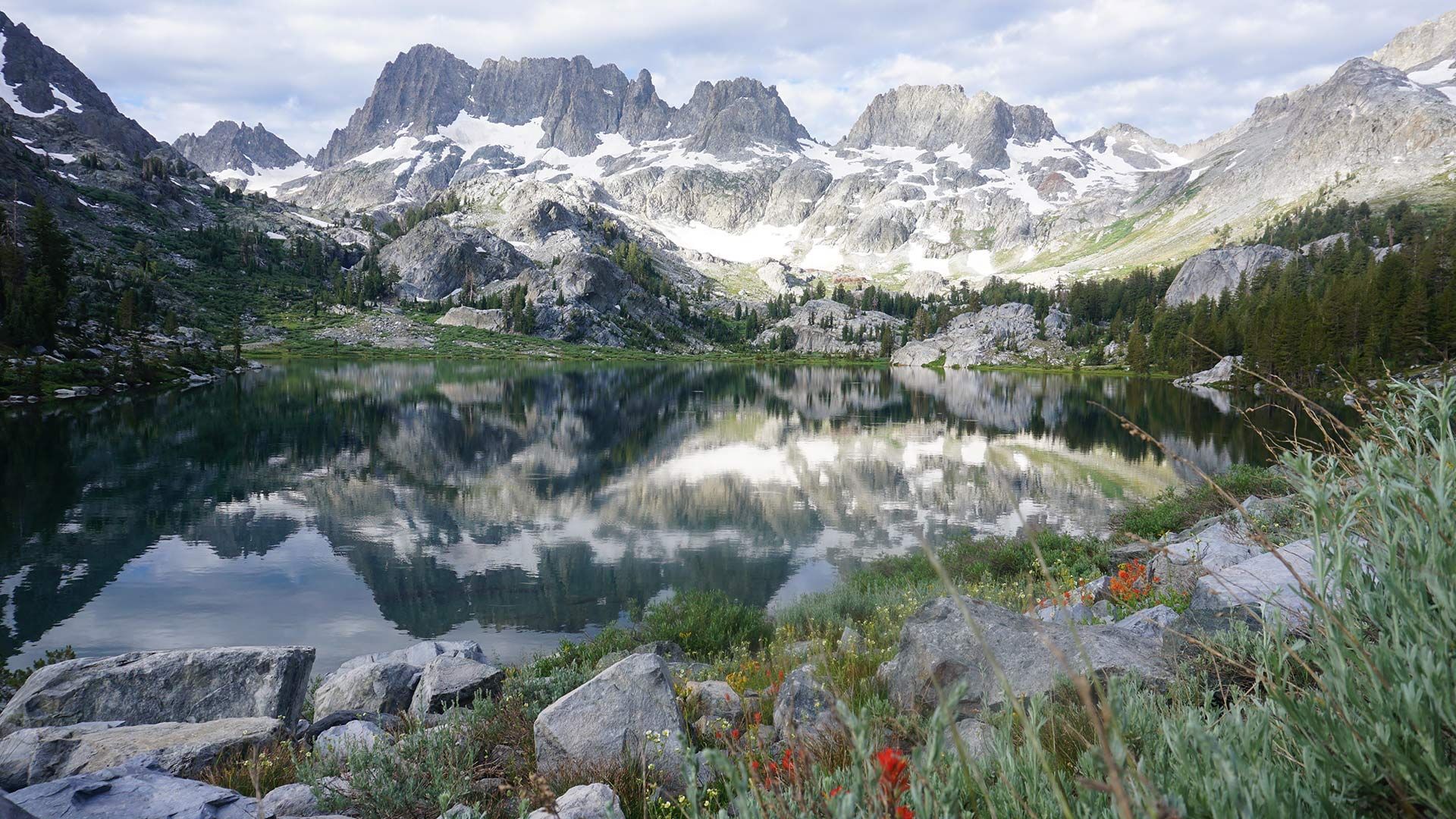 A mountain landscape with a lake and mountains in the background