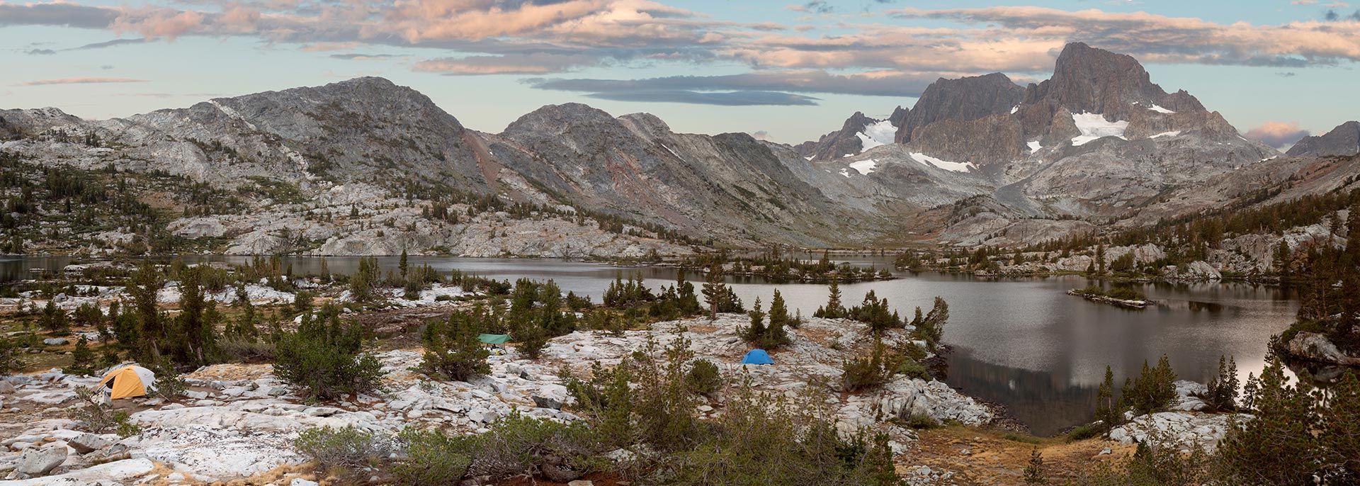 A mountain landscape with a lake and mountains in the background