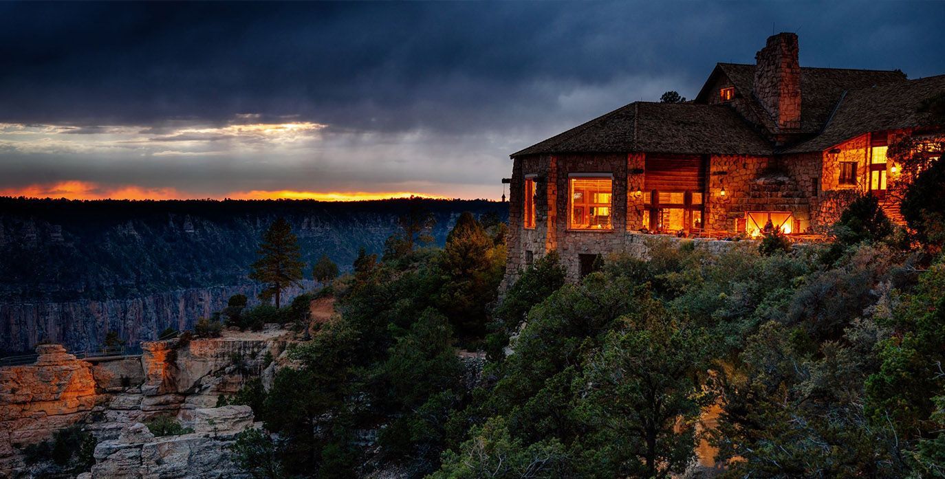 A Large House is Sitting on Top of a Cliff at Sunset