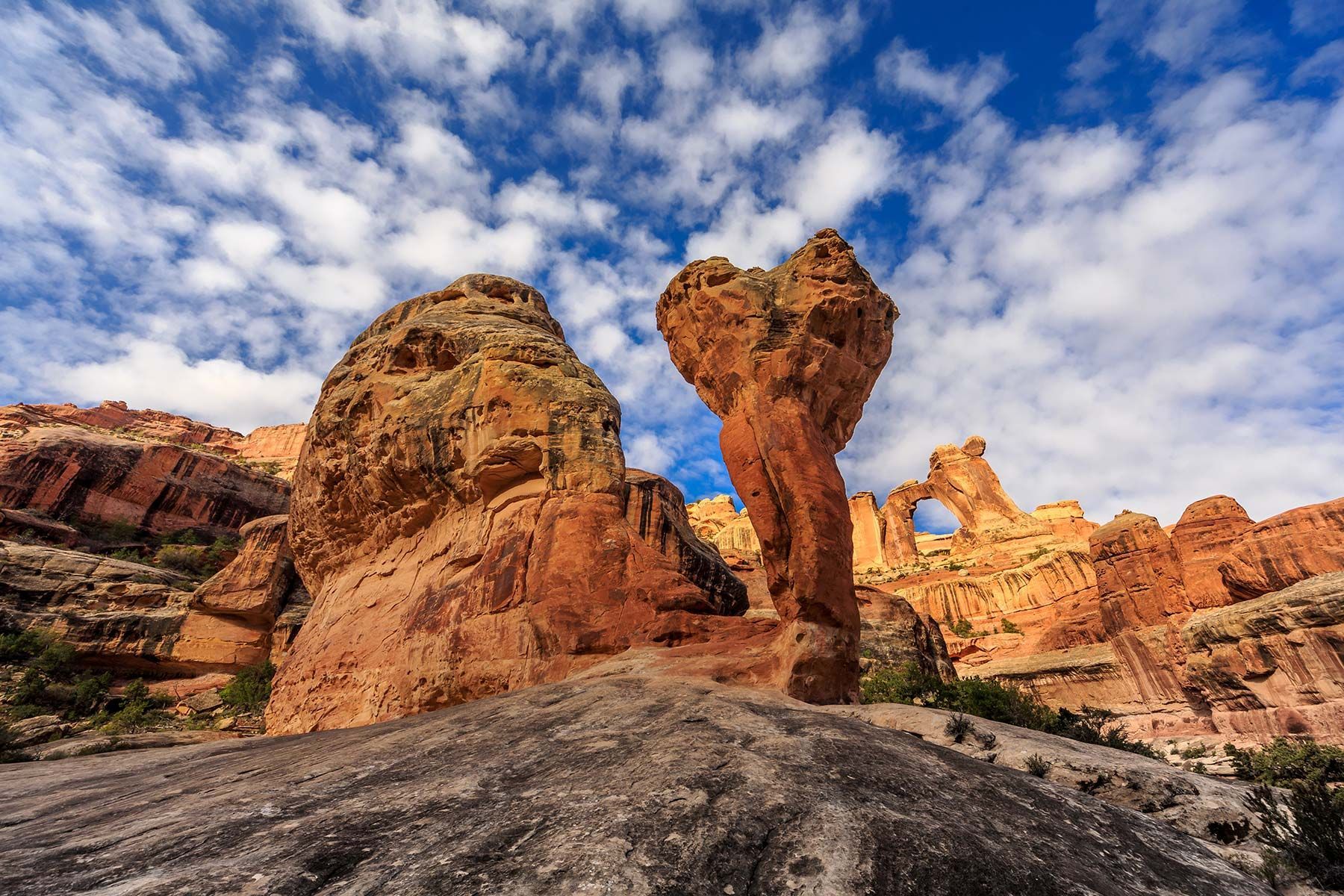 A large rock formation in the middle of a desert.