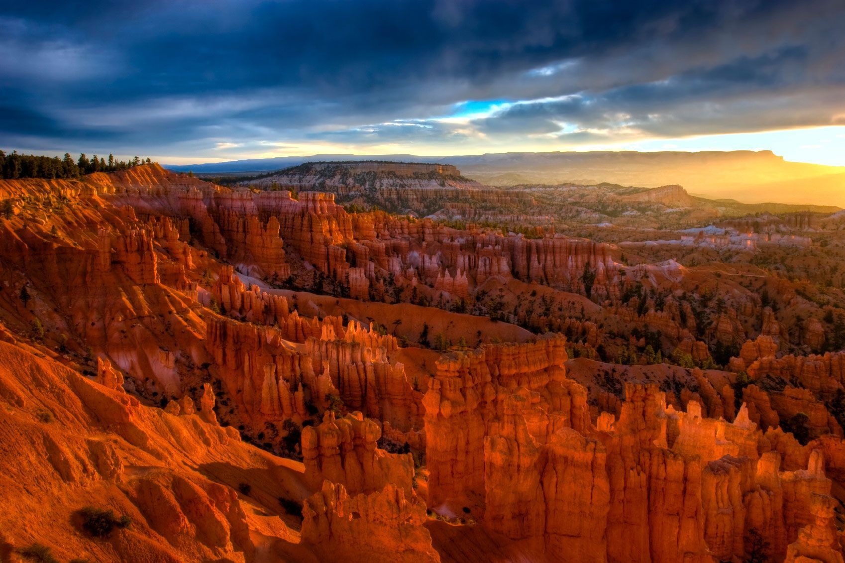 A view of a canyon with a sunset in the background.