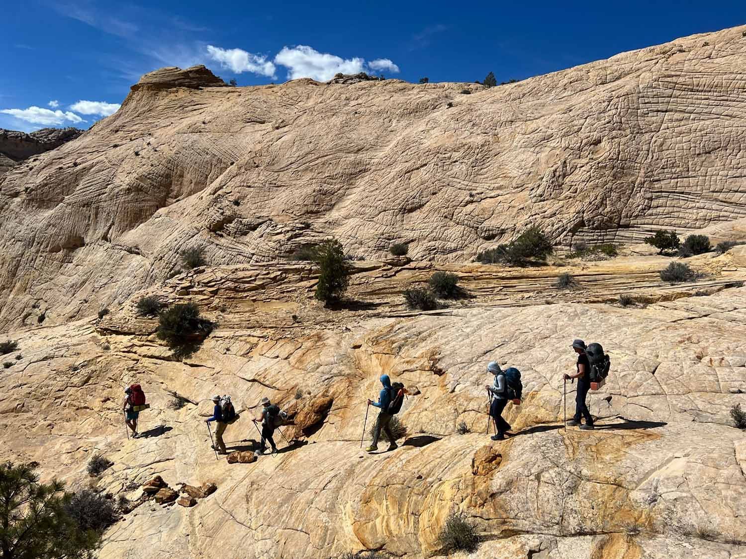 A Group of People Are Hiking Up a Mountain