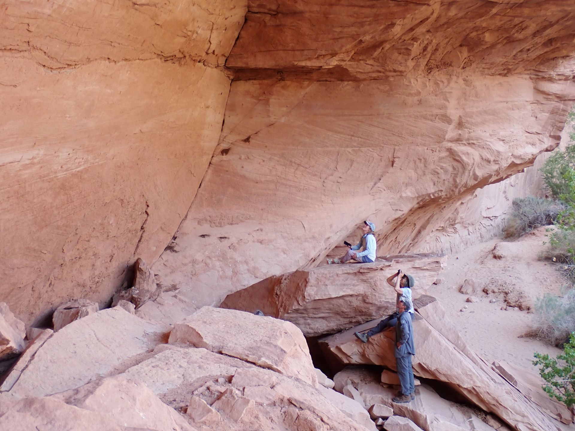 Two people are standing on a rock in a cave.