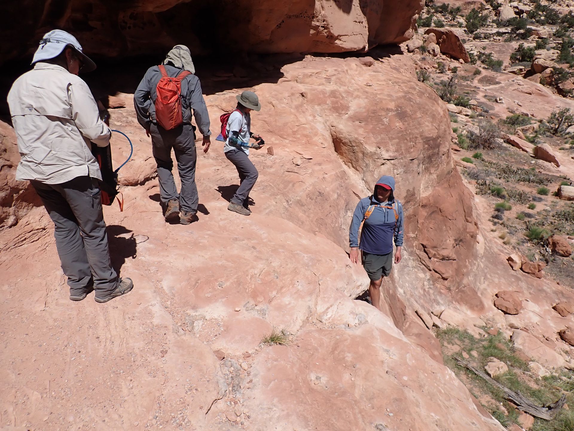 people going down the side of a mountain 