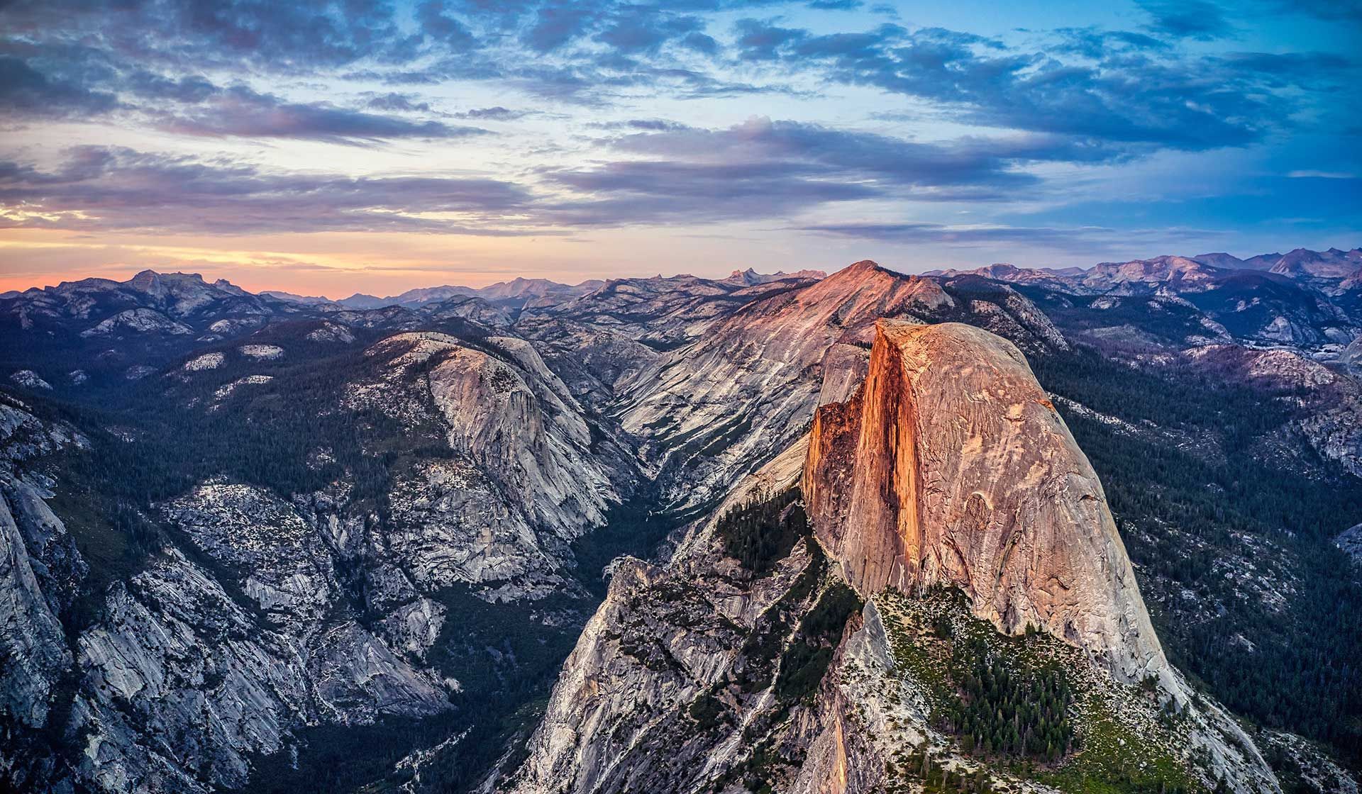 An aerial view of a mountain range at sunset.