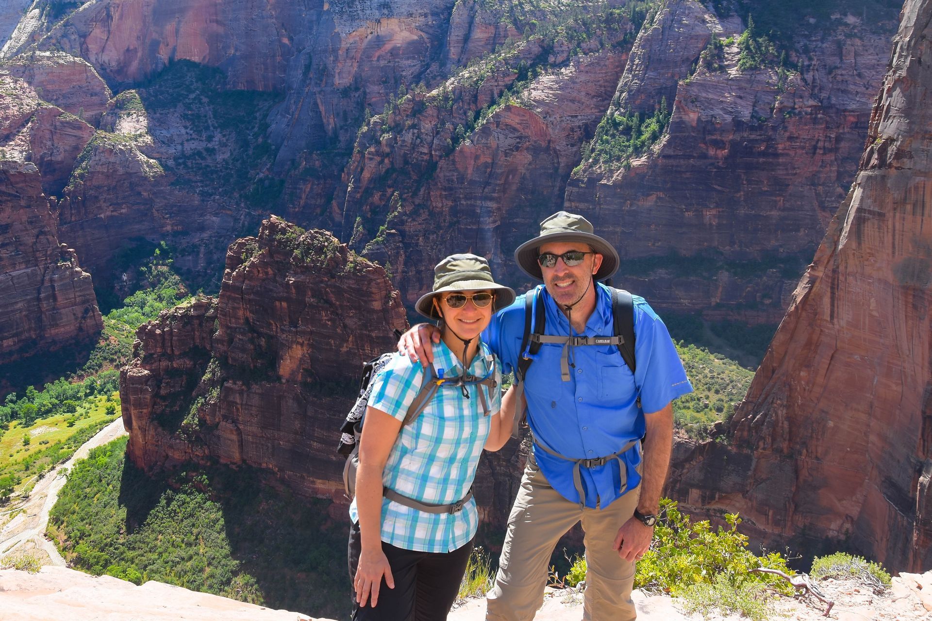 A group of people are jumping in the air in front of a mountain.