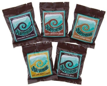 Five bags of hoppybar chocolate bars are sitting on top of each other on a table.