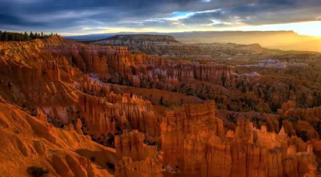 A view of a canyon with a sunset in the background.