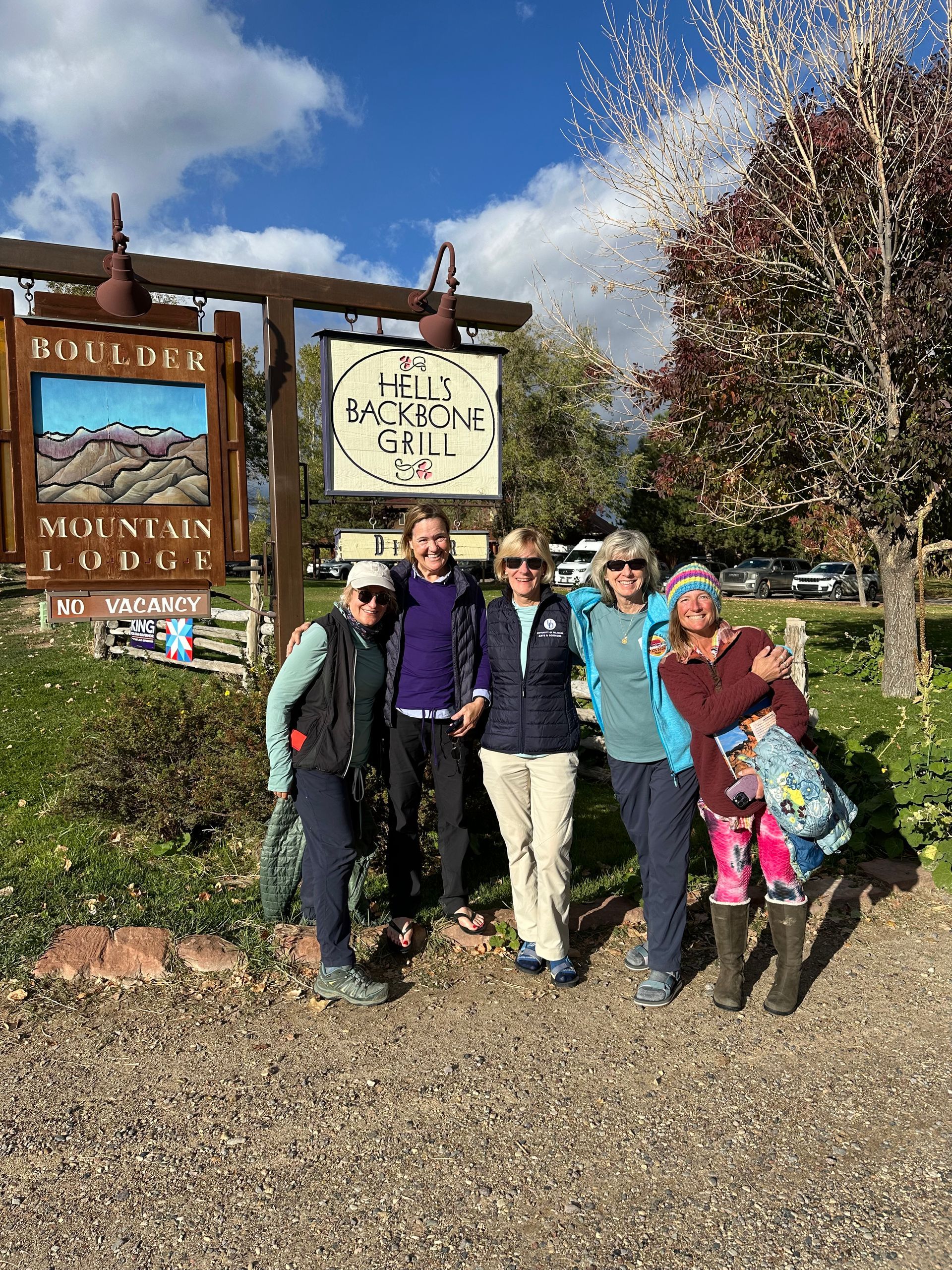 A group of people are posing for a picture in front of a sign.