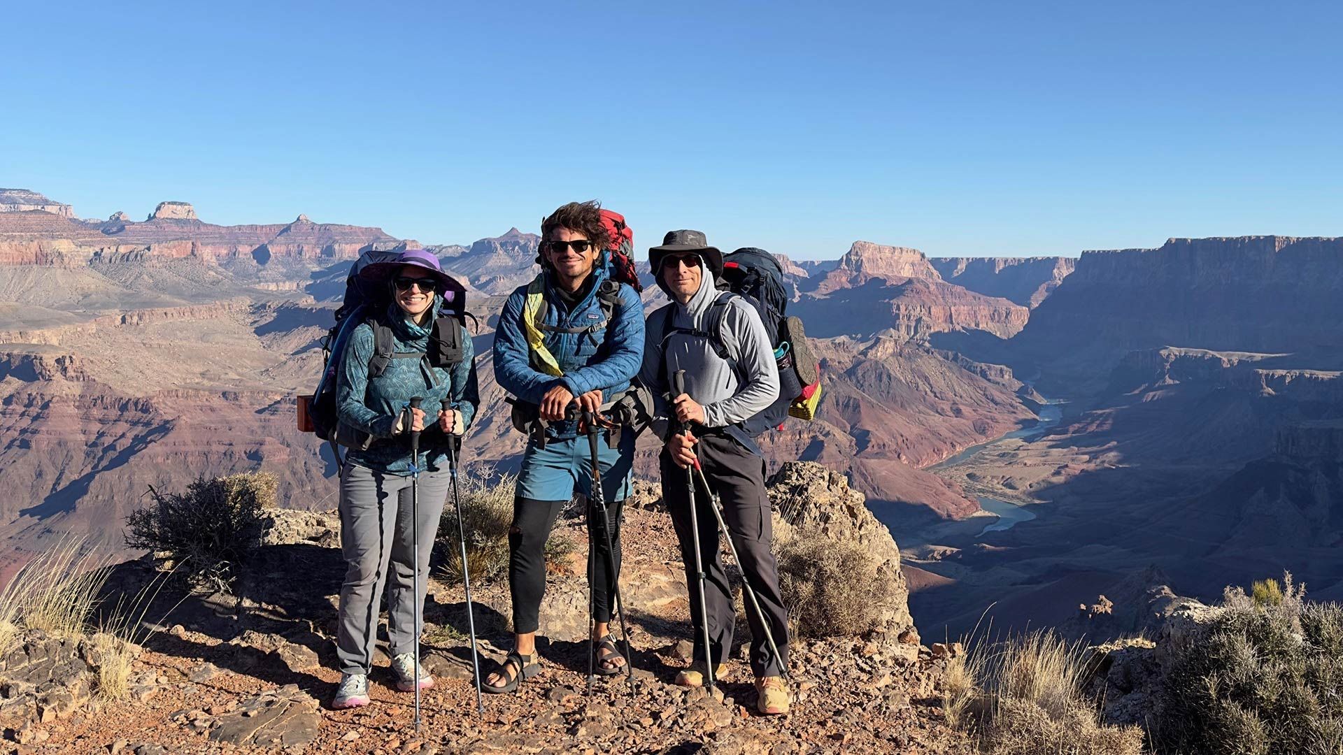 A man with a backpack is giving a high five to another man