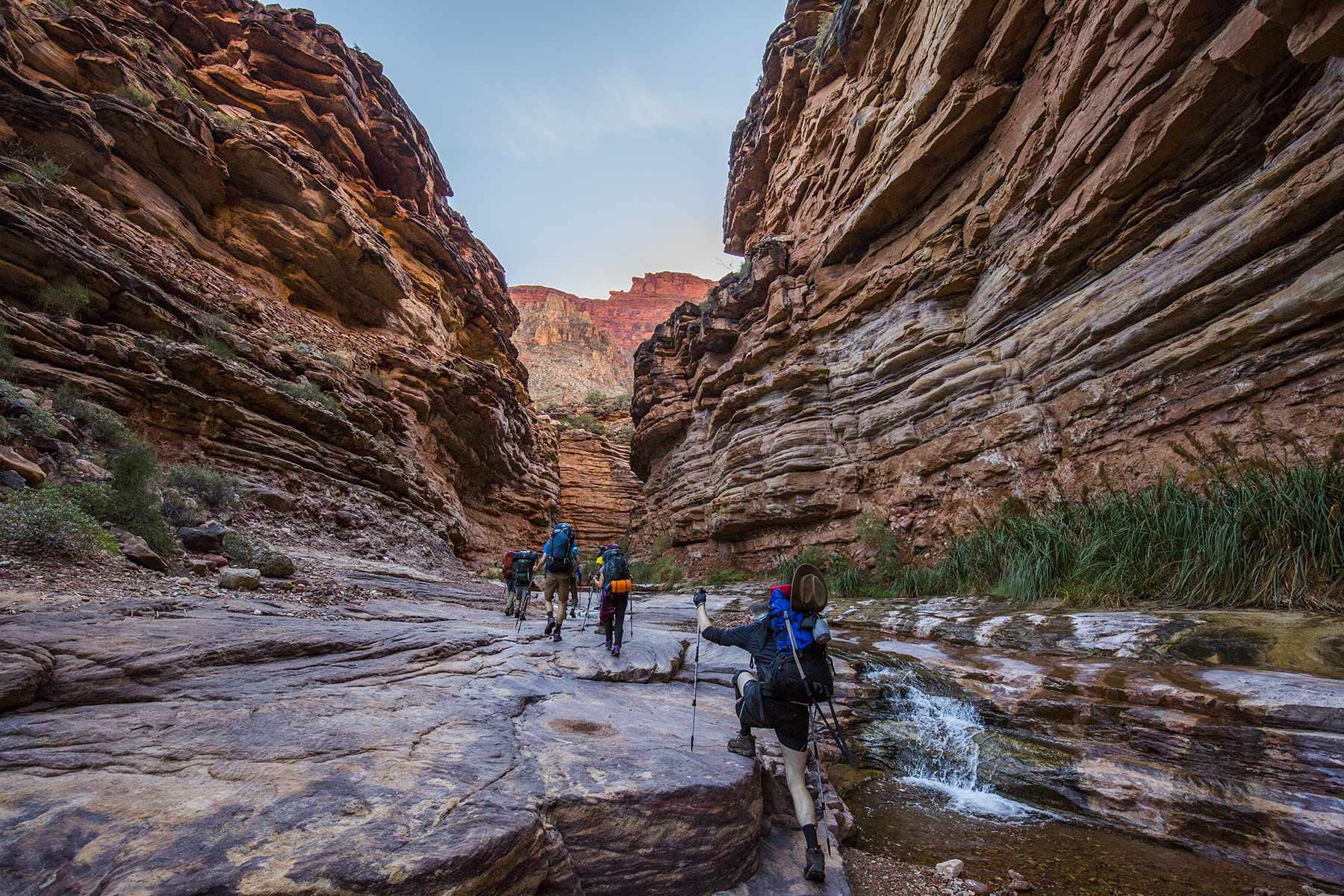 People hike through a majestic canyon