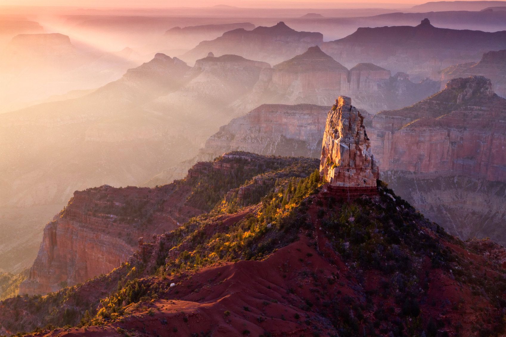 A mountain peak in the Grand Canyon  a t  sunset