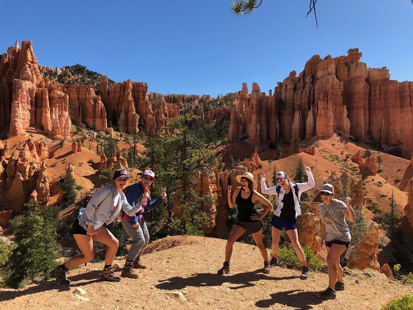 A Group of People Are Posing for A Picture in Front of A Canyon