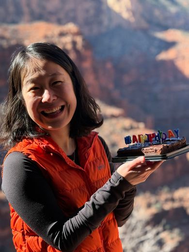 A Person With a Backpack Standing on Top of a Mountain