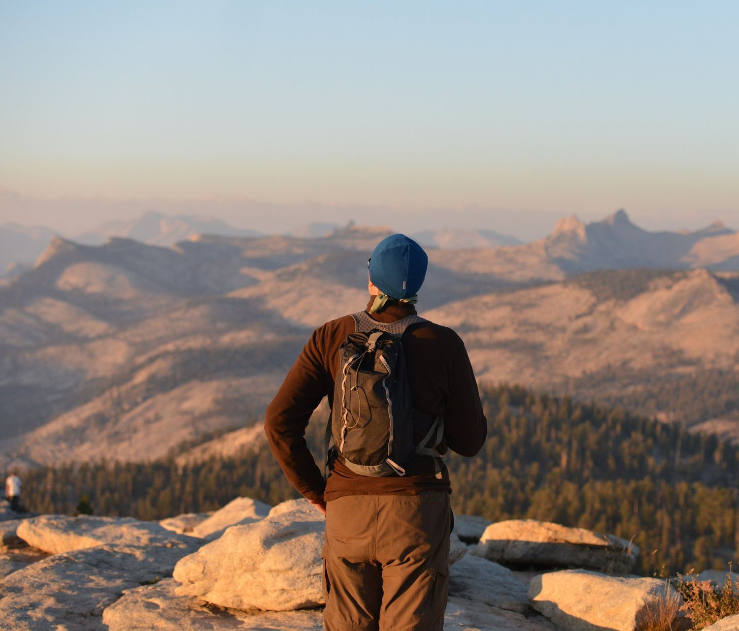 A Person With a Backpack Standing on Top of a Mountain