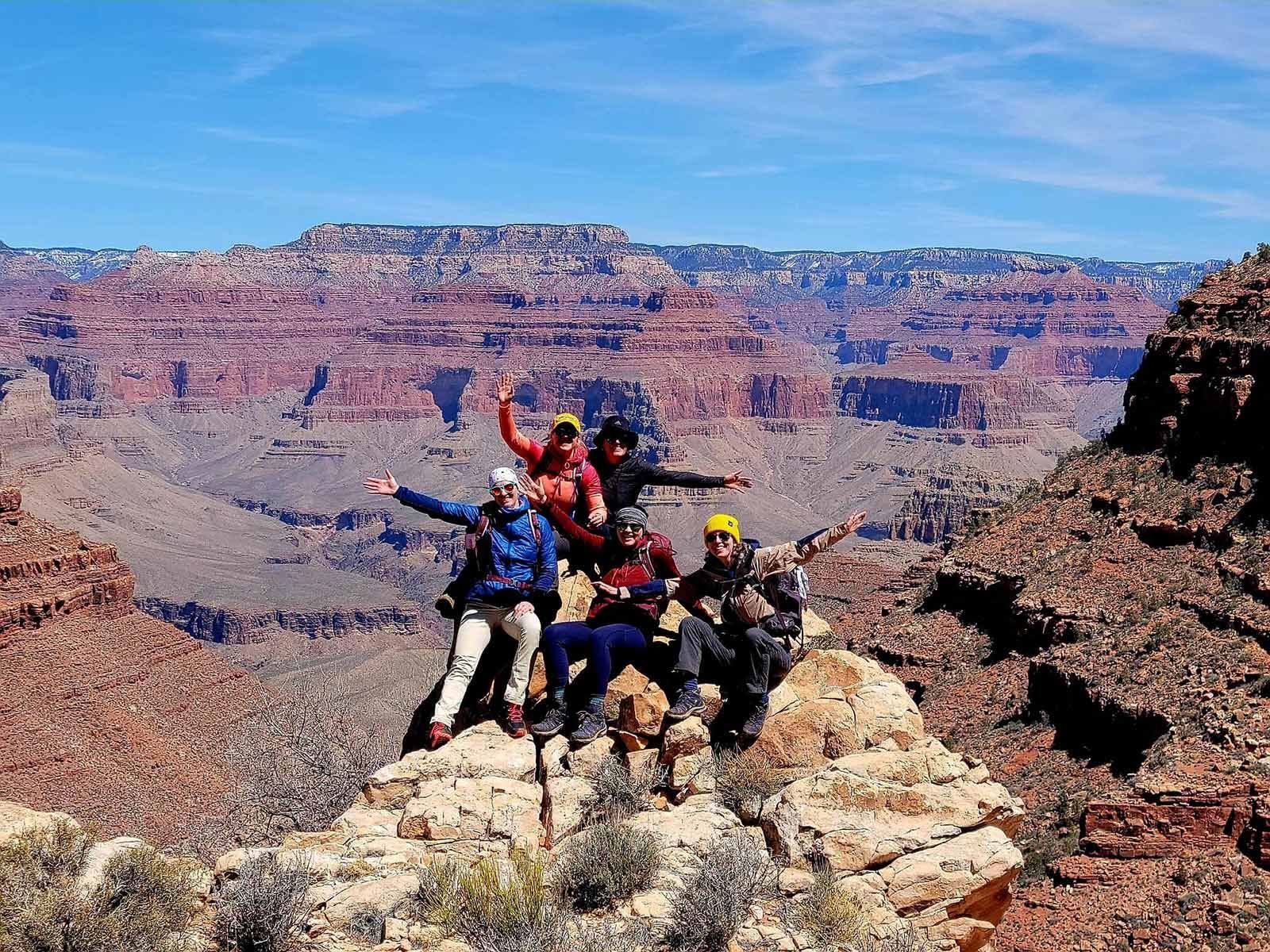People pose along the rim of the Grand Canyon
