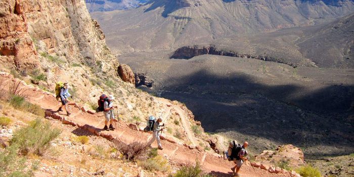 A group of people are hiking up a mountain.