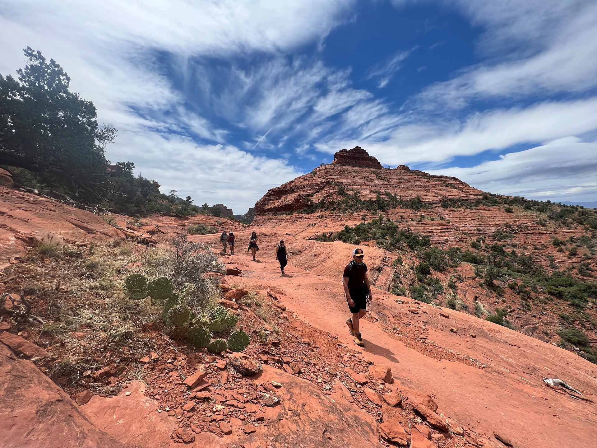 people walking in arizona near a mountain