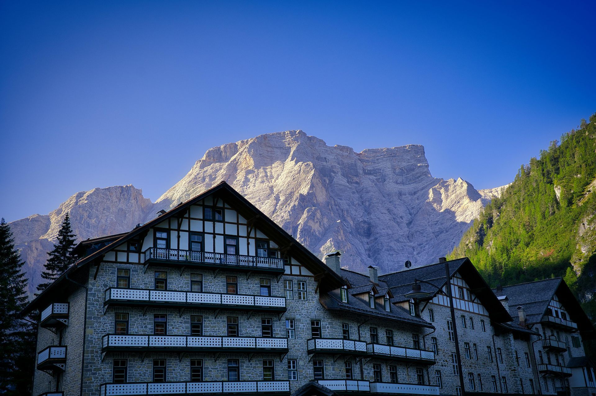 Hikers on a rocky trail in a mountain canyon. Sunny day, carrying backpacks.