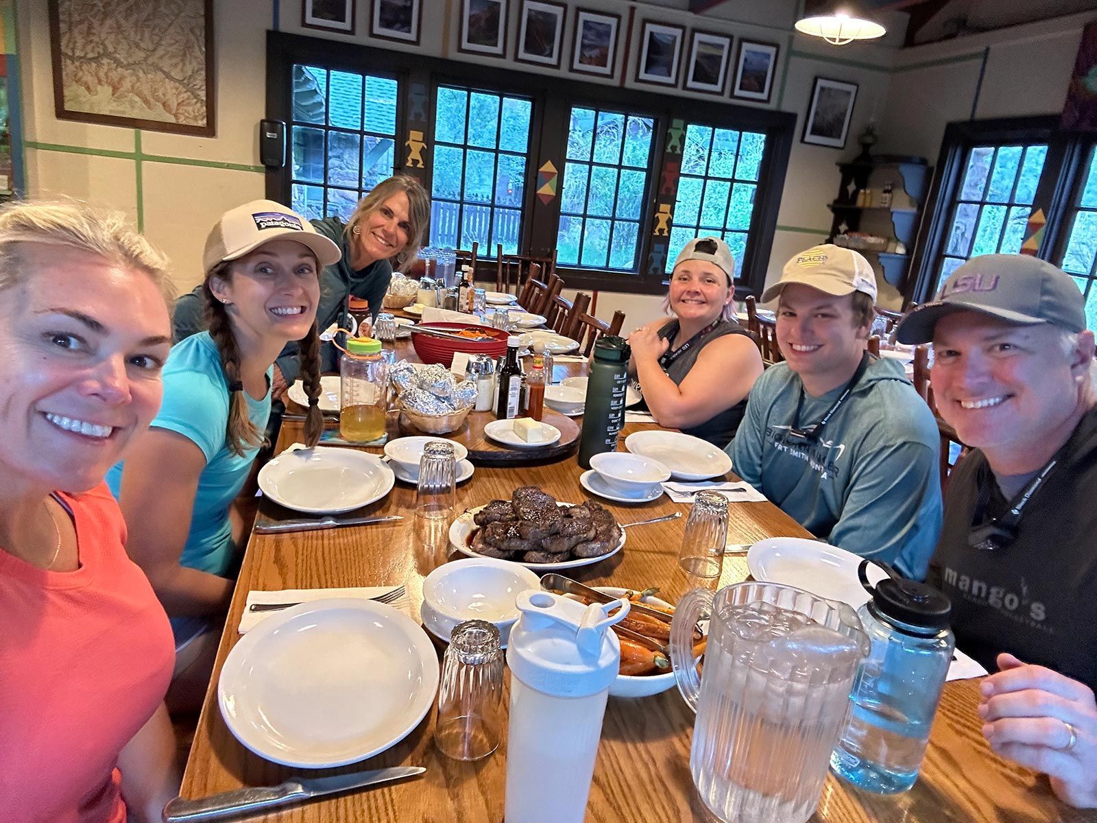 A group of people are sitting at a table with plates of food.