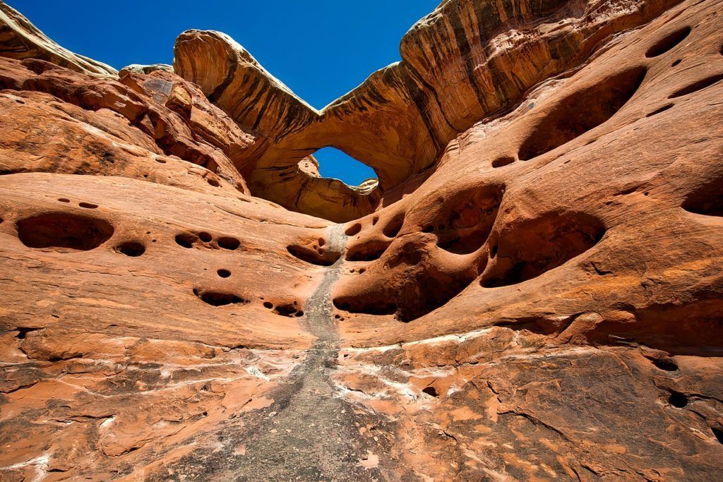 Looking up at a rock formation with a blue sky in the background