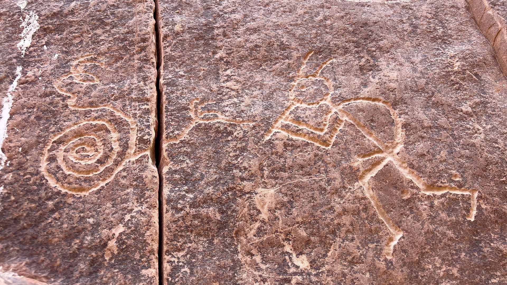 A close up of a rock with a drawing of a person on it.