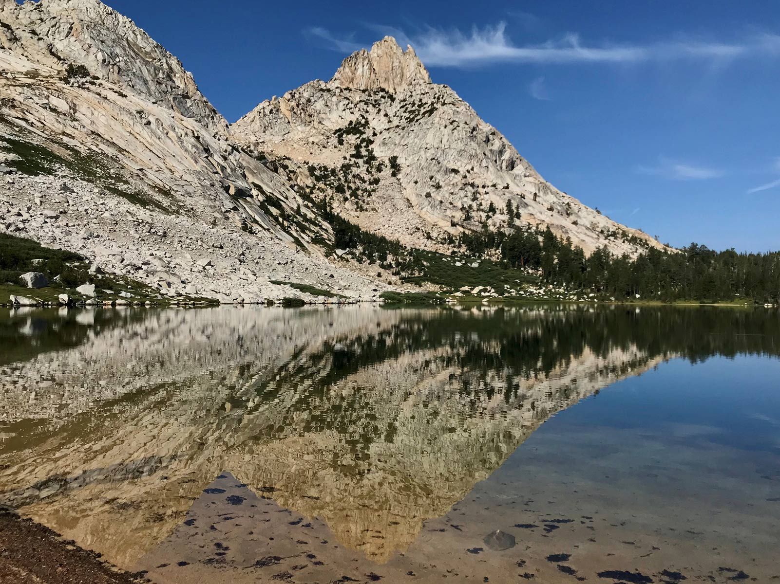 a large mountain and lake reflecting 