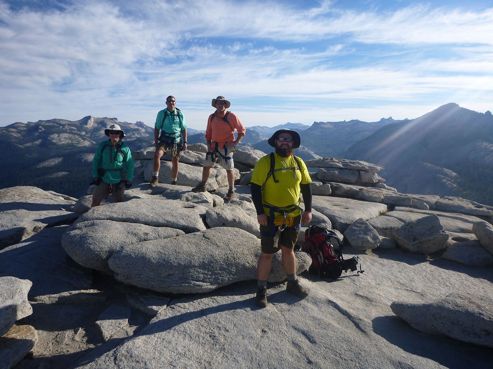 A group of people standing on top of a rocky mountain