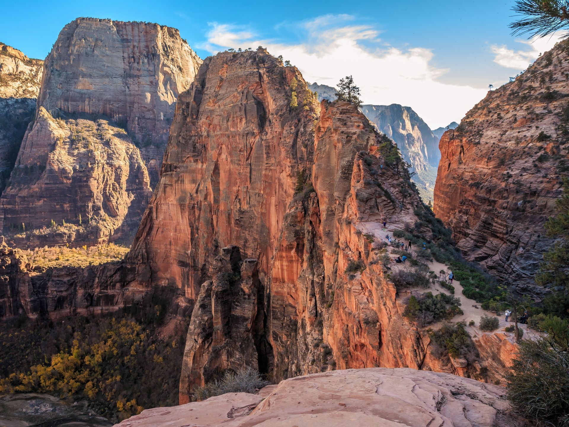 A group of people standing next to each other on top of a mountain.